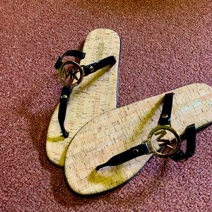 MK black sandals with good accents .